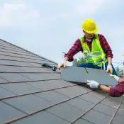 man cutting the rubber shingle