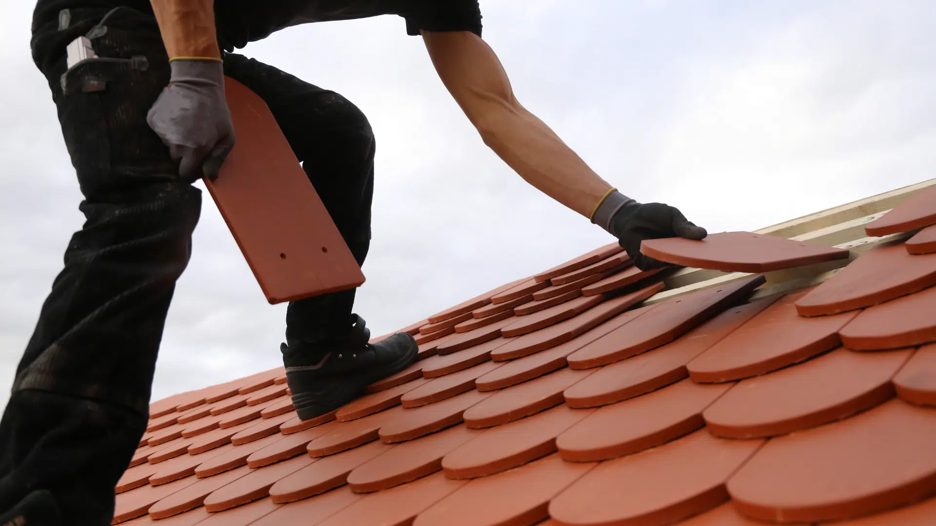 man installing roof tile