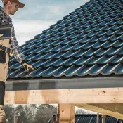 man checking the finished roof