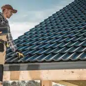 man wearing red cap near the roof