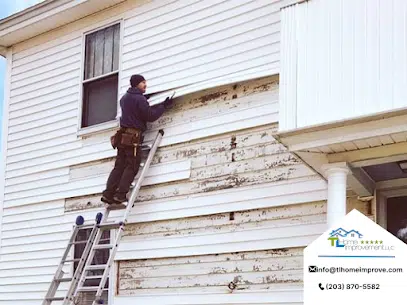 man replacing the vinyl siding