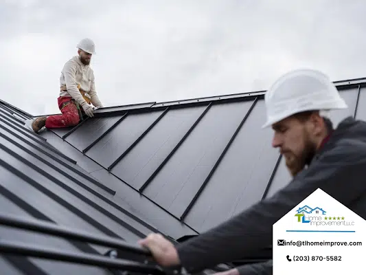 man wearing white hard hat sitting on top of the roof