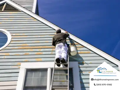 man on the ladder checking the roof